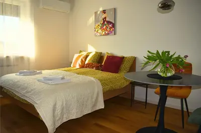 a small room with a bed and a table at Ahat apartment in Maribor