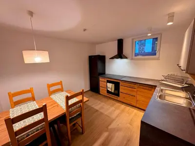 a kitchen and dining room with a table and a dining room gmaxwell gmaxwell gmaxwell gmaxwell at Apartma Oblak in Kranjska Gora