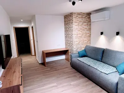 a living room with a couch and a table at Apartma Oblak in Kranjska Gora