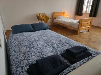 a bedroom with a bed with towels on it at Rooms in Maribor Centre in Maribor