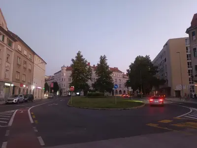 a city street with a car driving down the street at Rooms in Maribor Centre in Maribor