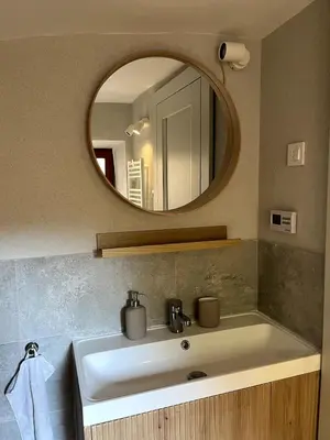 a bathroom with a sink and a mirror at Old town studio apartment in Ljubljana
