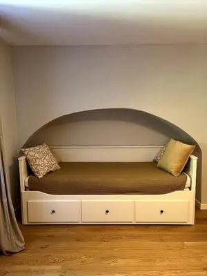 a bed with two pillows on it in a room at Old town studio apartment in Ljubljana