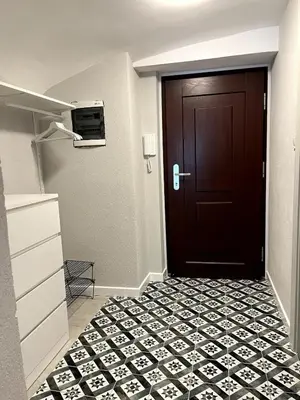 a door in a room with a tile floor at Old town studio apartment in Ljubljana