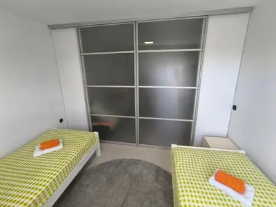 a room with two beds and a closet at Apartma JO-MA Mala Nedelja pri Bioterme in Mala Nedelja