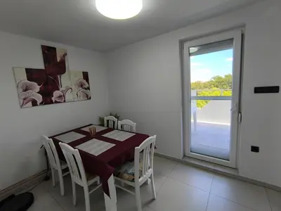 a dining room with a table and chairs and a window at Apartma JO-MA Mala Nedelja pri Bioterme in Mala Nedelja