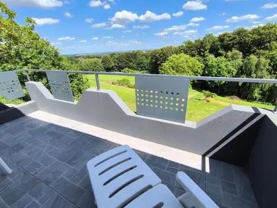 a balcony with white chairs and stairs on a roof at Apartma JO-MA Mala Nedelja pri Bioterme in Mala Nedelja