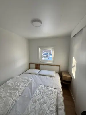 a small bedroom with a bed and a window at Hiška Moravska ravnica in Moravske Toplice