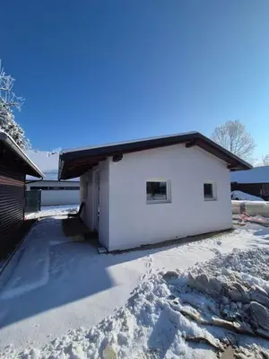 a white house with snow on the ground at Hiška Moravska ravnica in Moravske Toplice