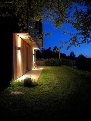 a building with a light on the side of a yard at Magda POP UP in Šentvid pri Stični