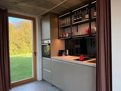a kitchen with a counter and a large window at Magda POP UP in Šentvid pri Stični