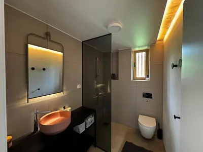 a bathroom with a sink and a toilet and a mirror at Magda POP UP in Šentvid pri Stični