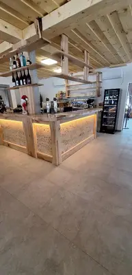 a bar in a building with a wooden counter at Gostišče Jezersko in Zgornje Jezersko