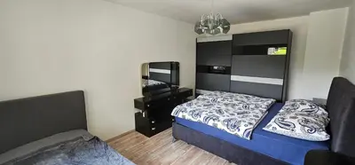 a small bedroom with a bed and a mirror at Apartment Milan in Zreče