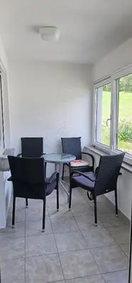 a room with chairs and a table and a window at Apartment Milan in Zreče