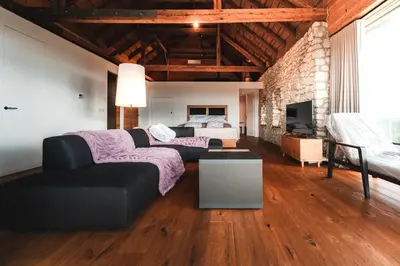 a living room with a couch and a bed at Vila Podigrac in Zgornja Kungota