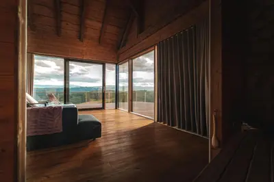 a living room with a couch and large windows at Vila Podigrac in Zgornja Kungota