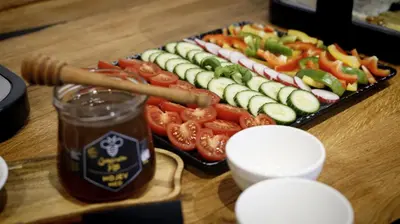 a table with a tray of vegetables and a jar of sauce at Turistična kmetija in pivovarna Flajs in Žalec