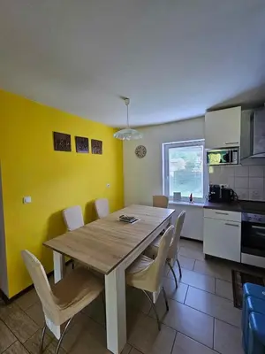 a dining room with a wooden table and chairs at Loginn Vic in Ljubljana