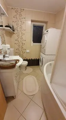 a bathroom with a toilet and a sink and a tub at Loginn Vic in Ljubljana