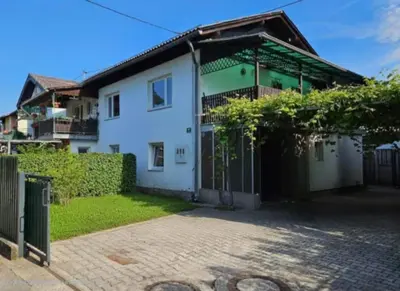 a white house with a gate and a driveway at Loginn Vic in Ljubljana