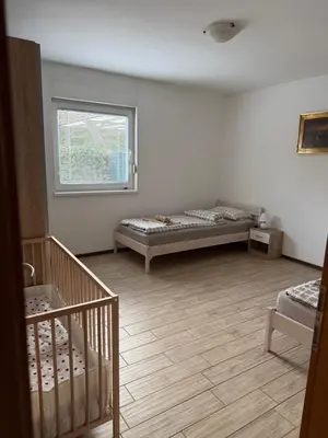 a room with two beds and a window at Loginn Vic in Ljubljana