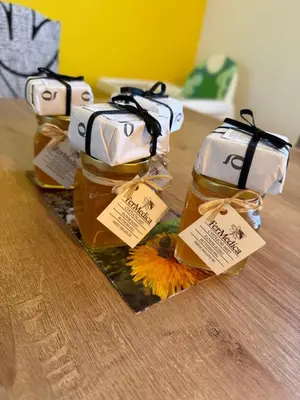a group of three jars of honey on a table at Loginn Vic in Ljubljana