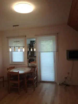 a dining room with a table and a window at vintage paradise near Kranjska Gora in Mojstrana