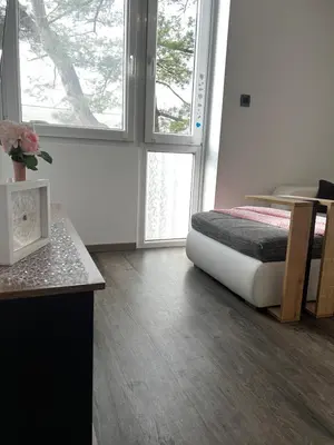 a bedroom with a bed sitting on the floor at D&D Sunny Ljubljana apartment in Vič