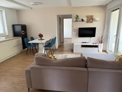 a living room with a couch and a table at Two bedrom Modern Flat near Ljubljana Private Garage &Balcony in Dobrova