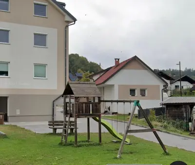 a playground with a slide in a yard at Two bedrom Modern Flat near Ljubljana Private Garage &Balcony in Dobrova