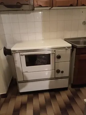 a kitchen with a white oven in a kitchen at Apartma pri Ivanu in Spodnja Idrija