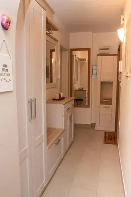 a kitchen with white cabinets and a counter at Little Oasis Apartment in Zgornje Gorje