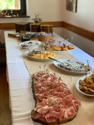 a long table with many plates of food on it at Penzion Sinji vrh in Zoll