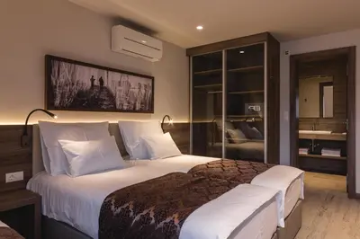 a bedroom with a large bed with white pillows at Guesthouse Grof in Vransko