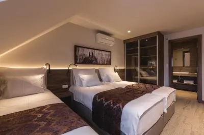 a hotel room with two beds and a bathroom at Guesthouse Grof in Vransko