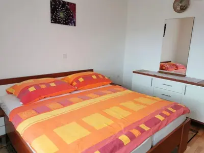 a bedroom with a bed with orange and orange pillows at Holiday Home Urlaub für die Seele - Ferienhaus mit Sauna by Interhome in Rucmanci