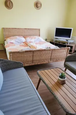 a living room with a bed and a table and a table sidx sidx at Holiday Home Urlaub für die Seele - Ferienhaus mit Sauna by Interhome in Rucmanci