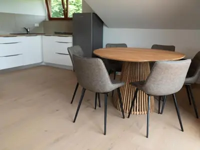 a kitchen with a wooden table and chairs at Apartment Natur- und Weinresort Lipej by Interhome in Bizeljsko