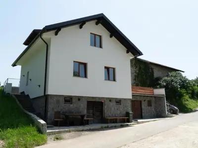 a white house with a table in front of it at Apartment Natur- und Weinresort Lipej by Interhome in Bizeljsko
