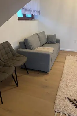 a living room with a couch and a chair at Apartment Natur- und Weinresort Lipej by Interhome in Bizeljsko