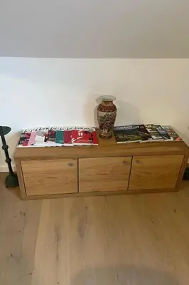 a wooden table with books and a vase on top of it at Apartment Natur- und Weinresort Lipej by Interhome in Bizeljsko
