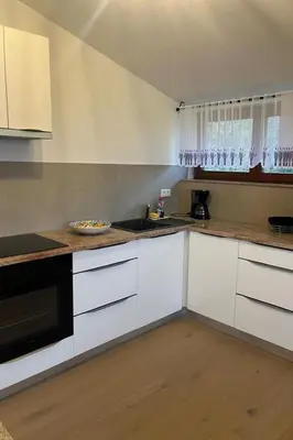 a kitchen with white cabinets and a counter top at Apartment Natur- und Weinresort Lipej by Interhome in Bizeljsko