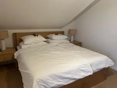 a large bed with white sheets and pillows at Apartment Natur- und Weinresort Lipej by Interhome in Bizeljsko