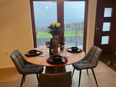 a table with chairs and a vase with flowers on it at Apartment Natur- und Weinresort Lipej by Interhome in Bizeljsko