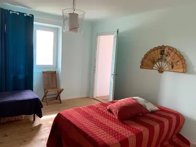 a bedroom with a bed with a red blanket at Vale