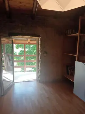 an empty room with a door and a room with wooden floors at Vale