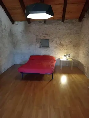 a room with a red bench and a table at Vale