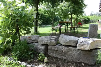 a stone wall with two chairs and a table at Vale