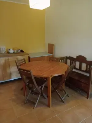 a wooden table and chairs in a room at Vale